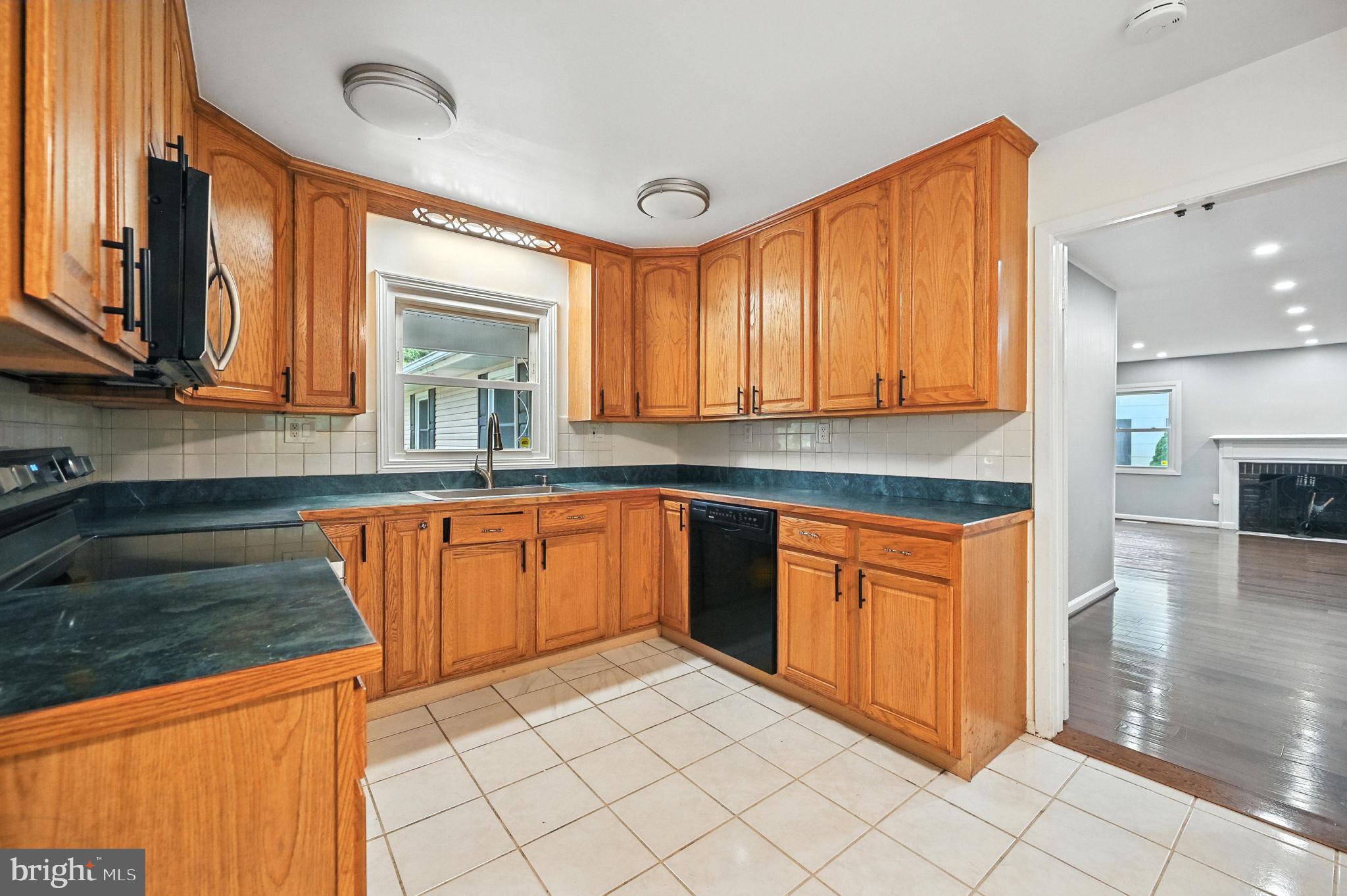 9301 Montpelier Drive Laurel, MD 20708 - Photo 8 of 23 a kitchen with stainless steel appliances granite countertop a sink and cabinets