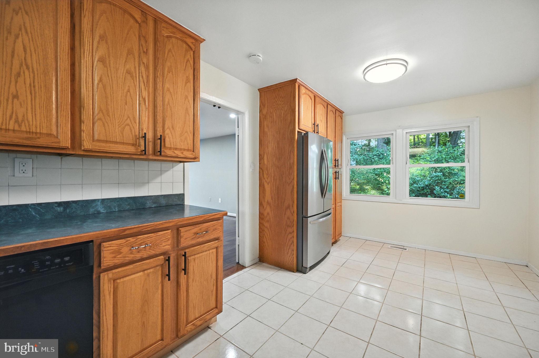 9301 Montpelier Drive Laurel, MD 20708 - Photo 9 of 23 a kitchen with stainless steel appliances granite countertop a refrigerator sink and cabinets