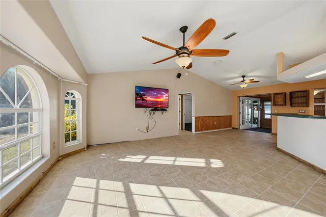 a view of a livingroom with a ceiling fan and window