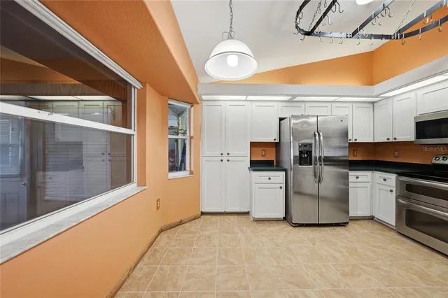 a kitchen with refrigerator and stove