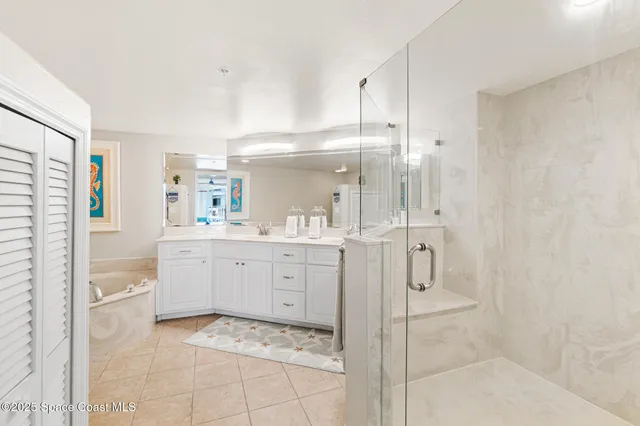 a spacious bathroom with a shower sink and mirror
