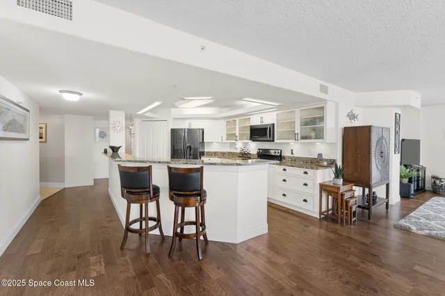 a kitchen with a sink and a refrigerator