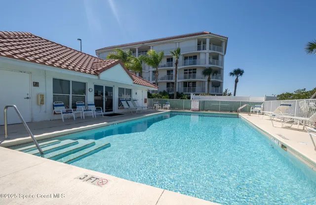 an aerial view of multiple houses with yard