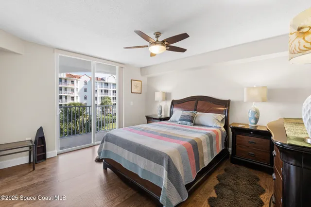 a bedroom with a bed and a view of living room