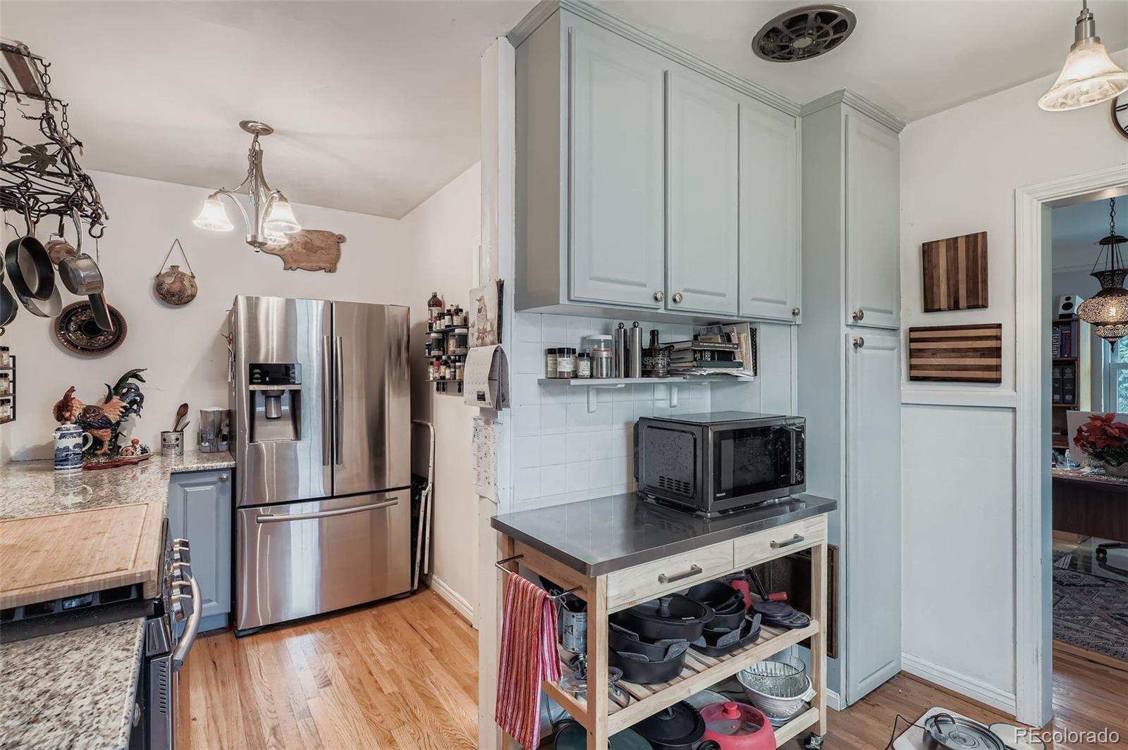 2520 North Locust Street Denver, CO 80207 - Photo 11 of 39 a kitchen with a refrigerator a stove and a sink