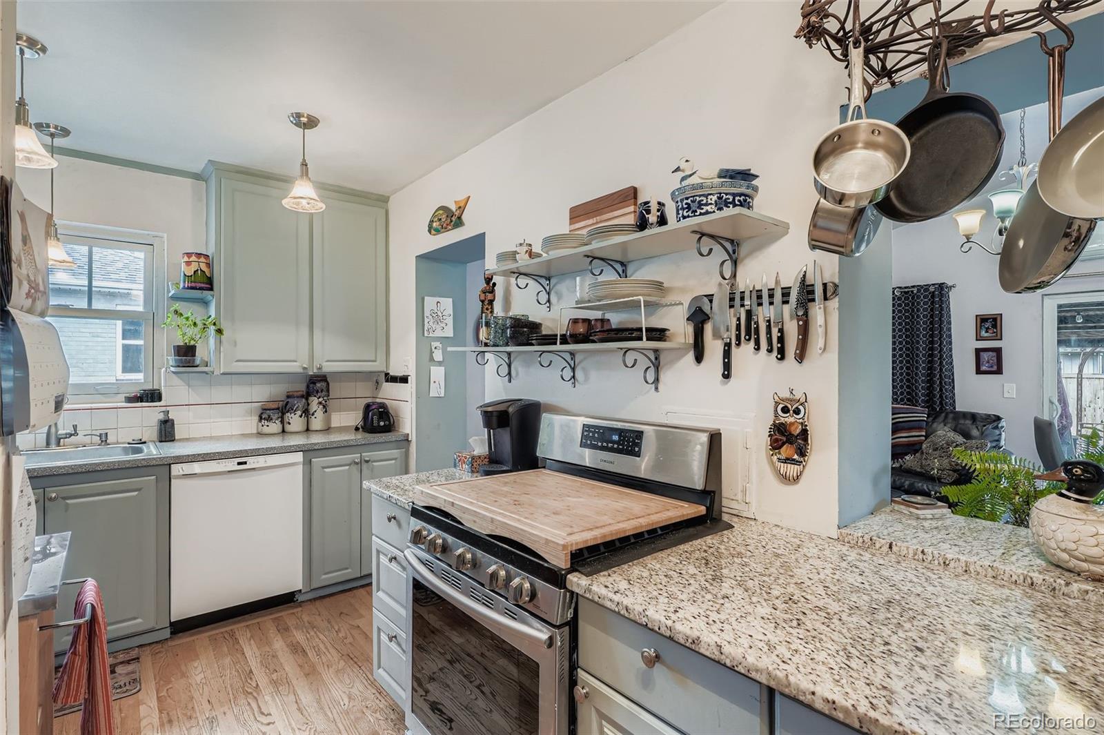 2520 North Locust Street Denver, CO 80207 - Photo 13 of 39 a kitchen with cabinets and wooden floor