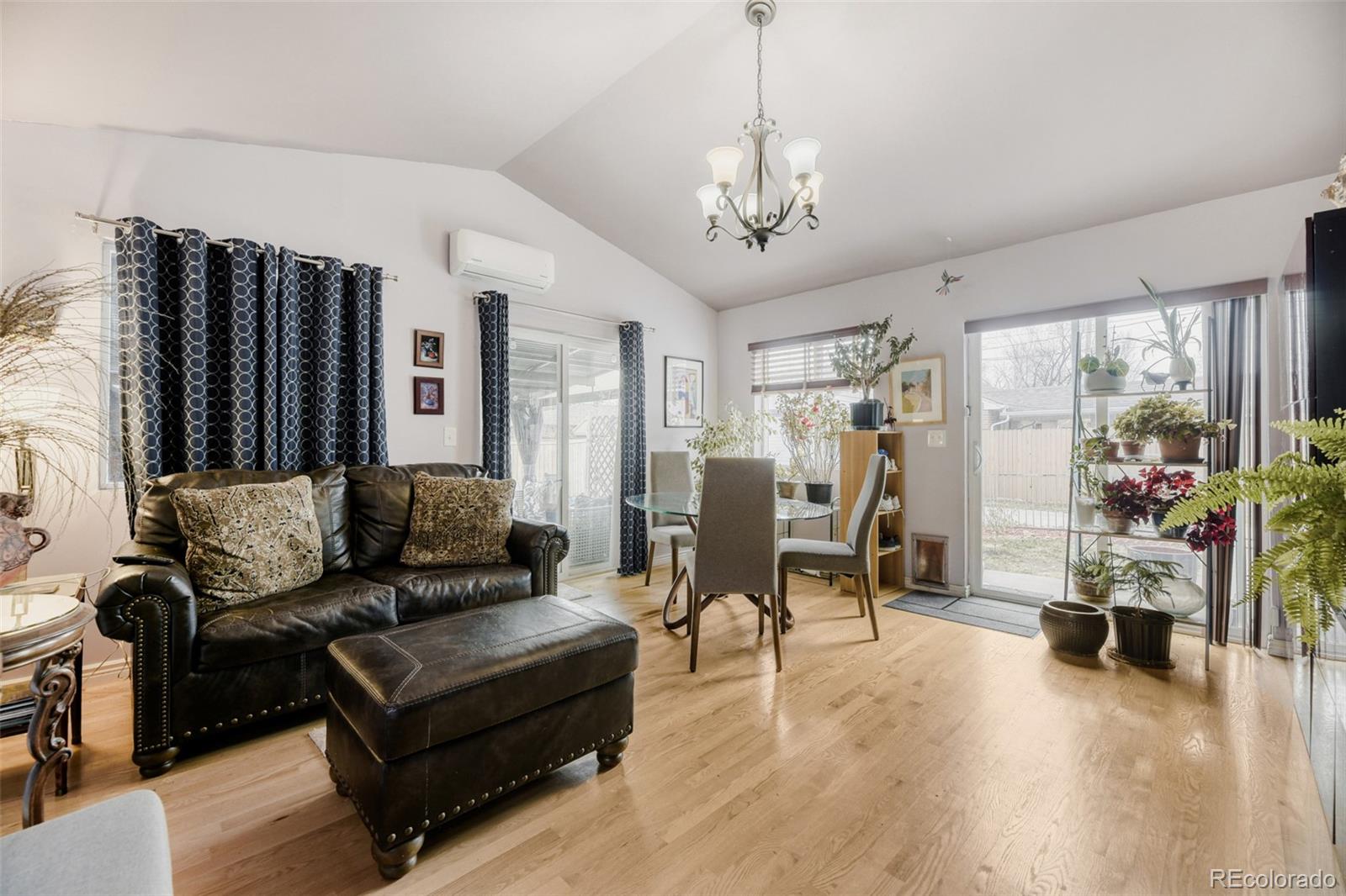 2520 North Locust Street Denver, CO 80207 - Photo 14 of 39 a living room with furniture and a chandelier