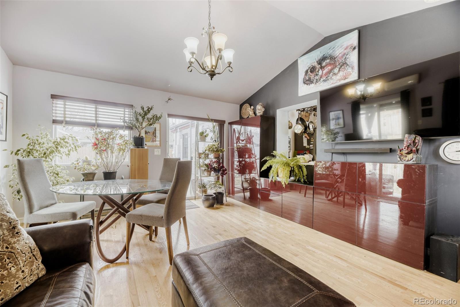 2520 North Locust Street Denver, CO 80207 - Photo 15 of 39 a view of a dining room and livingroom with furniture wooden floor a chandelier