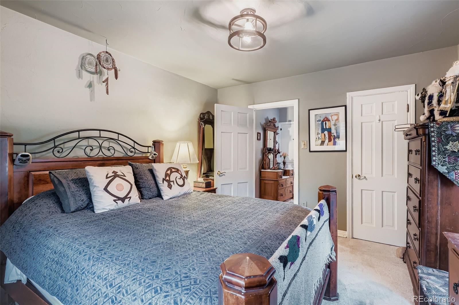 2520 North Locust Street Denver, CO 80207 - Photo 19 of 39 a bedroom with a bed and a walk in closet