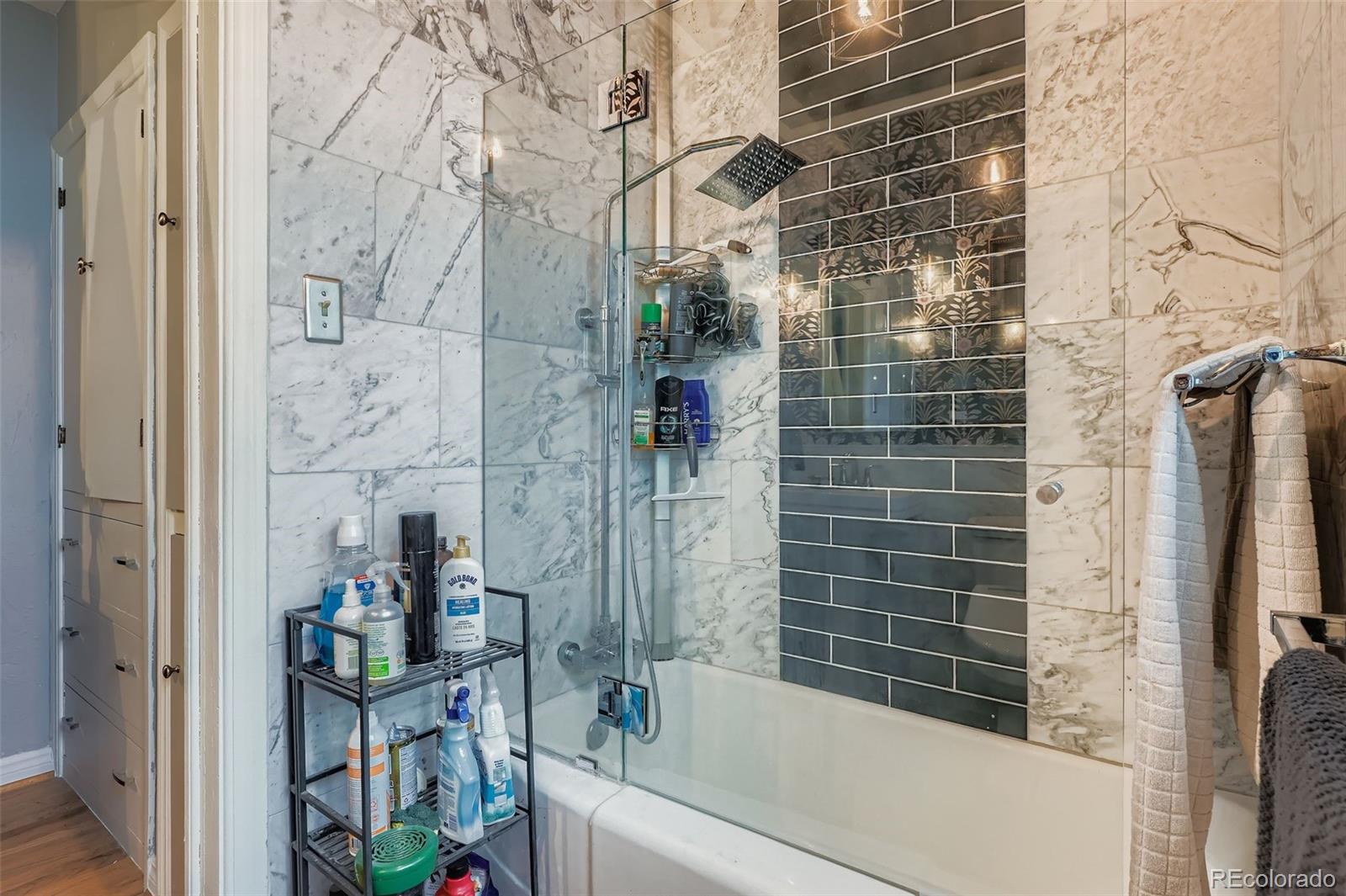 2520 North Locust Street Denver, CO 80207 - Photo 20 of 39 a bathroom with a bathtub and shower