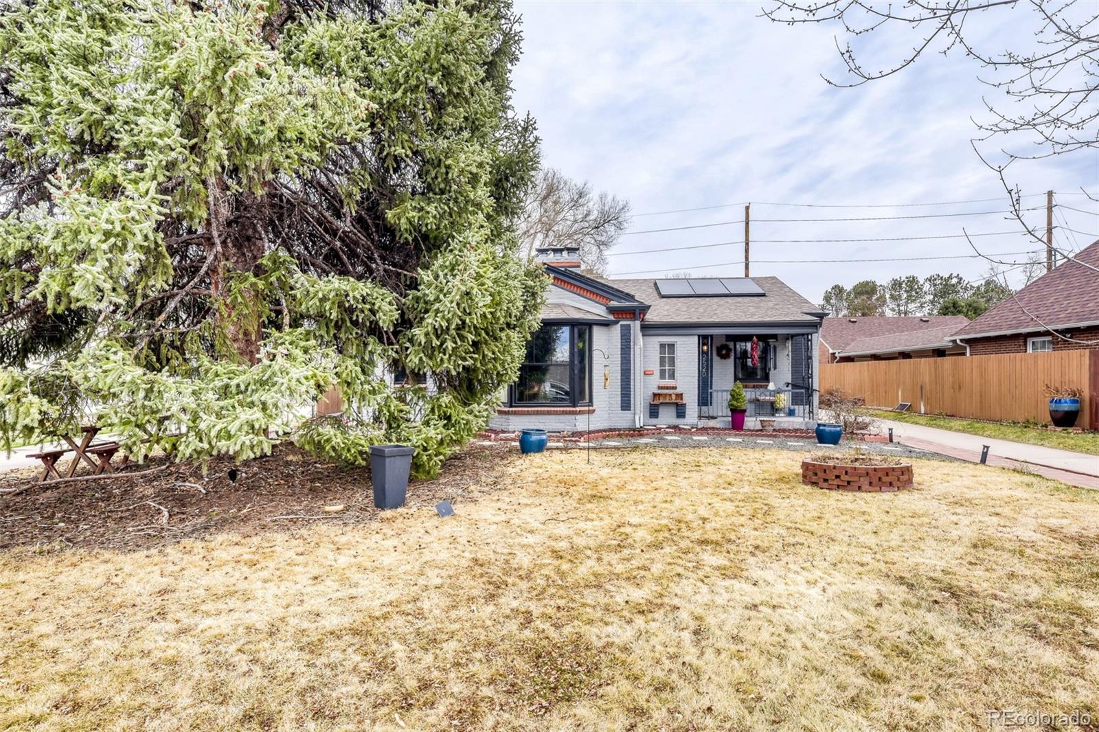 2520 North Locust Street Denver, CO 80207 - Photo 2 of 39 a front view of a house with yard patio and fire pit