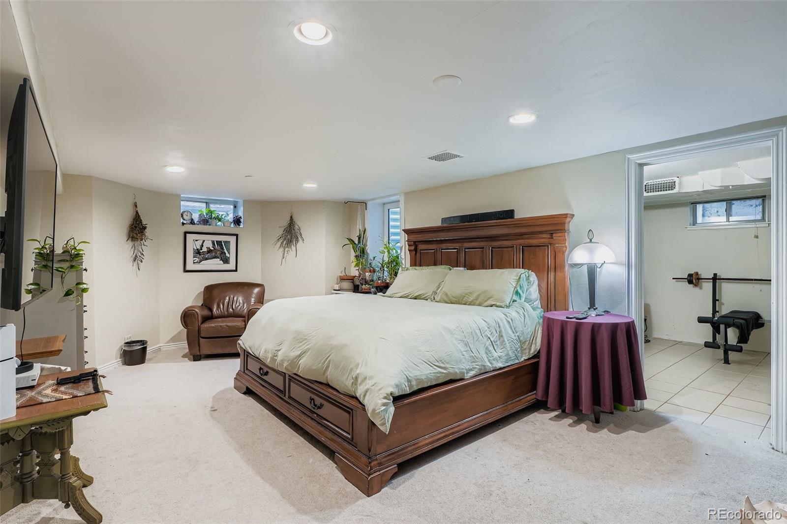 2520 North Locust Street Denver, CO 80207 - Photo 22 of 39 a bed room with a bed and a chair