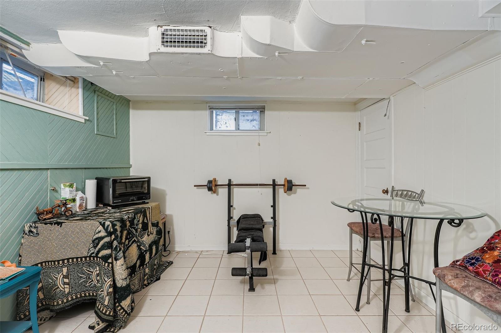 2520 North Locust Street Denver, CO 80207 - Photo 26 of 39 a room with furniture a flat screen tv and a fireplace