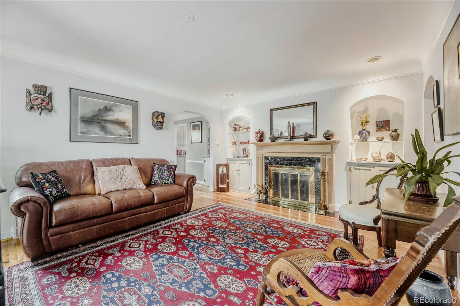 2520 North Locust Street Denver, CO 80207 - Photo 6 of 39 a living room with furniture and a fireplace