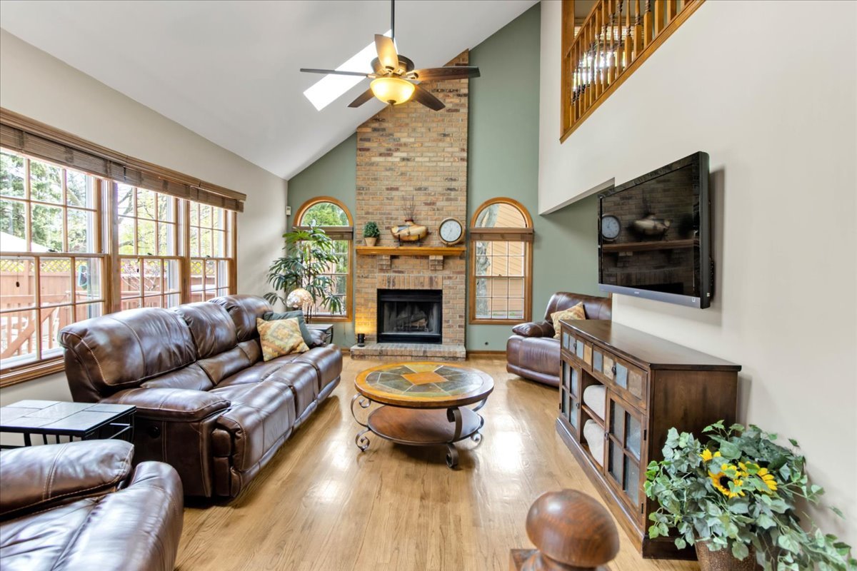 76 Red Fox Run Montgomery, IL 60538 - Photo 11 of 28 a living room with furniture a flat screen tv and a fireplace