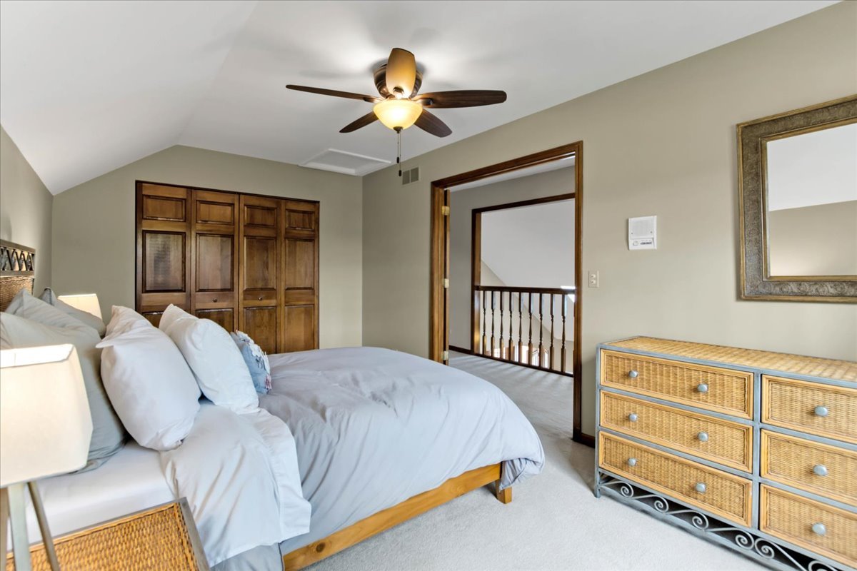 76 Red Fox Run Montgomery, IL 60538 - Photo 19 of 28 a bedroom with a bed and a chandelier