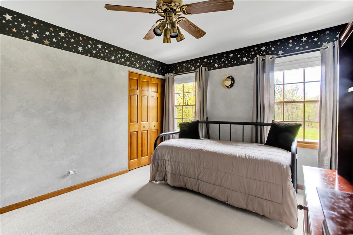 76 Red Fox Run Montgomery, IL 60538 - Photo 22 of 28 a bedroom with a large bed and a chandelier