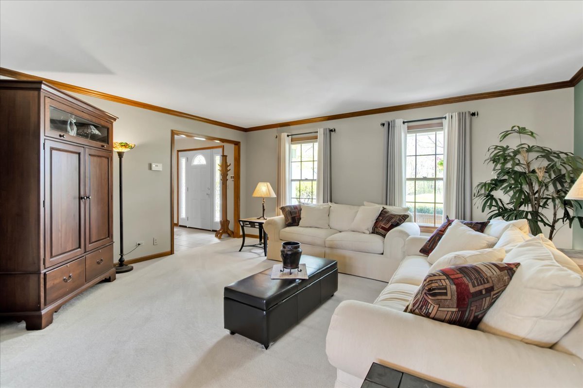 76 Red Fox Run Montgomery, IL 60538 - Photo 6 of 28 a living room with furniture ceiling fan and a window