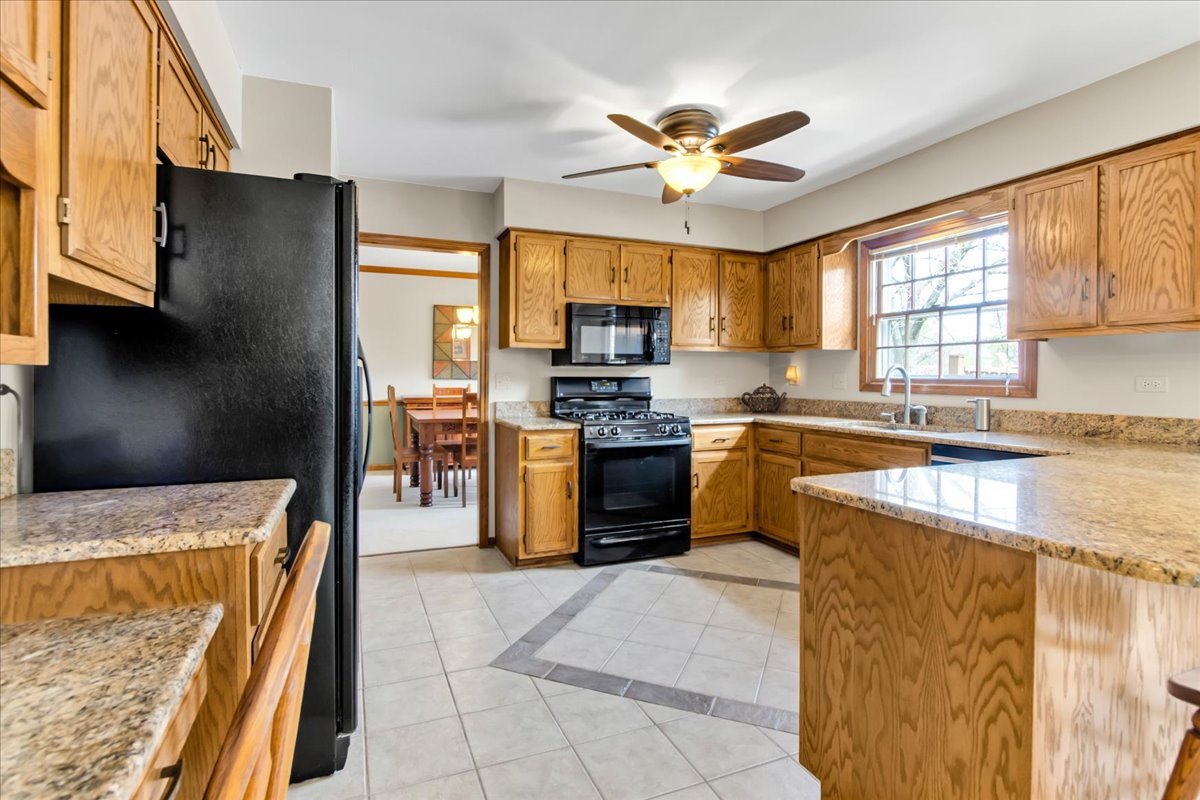 76 Red Fox Run Montgomery, IL 60538 - Photo 8 of 28 a kitchen with stainless steel appliances granite countertop a stove top oven a sink a counter top space and cabinets