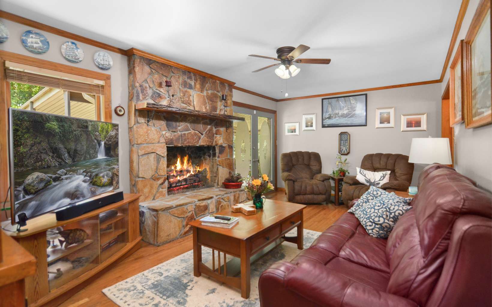 2850 Appalachian Highway Blue Ridge, GA 30513 - Photo 12 of 30 a living room with furniture a flat screen tv and a fireplace