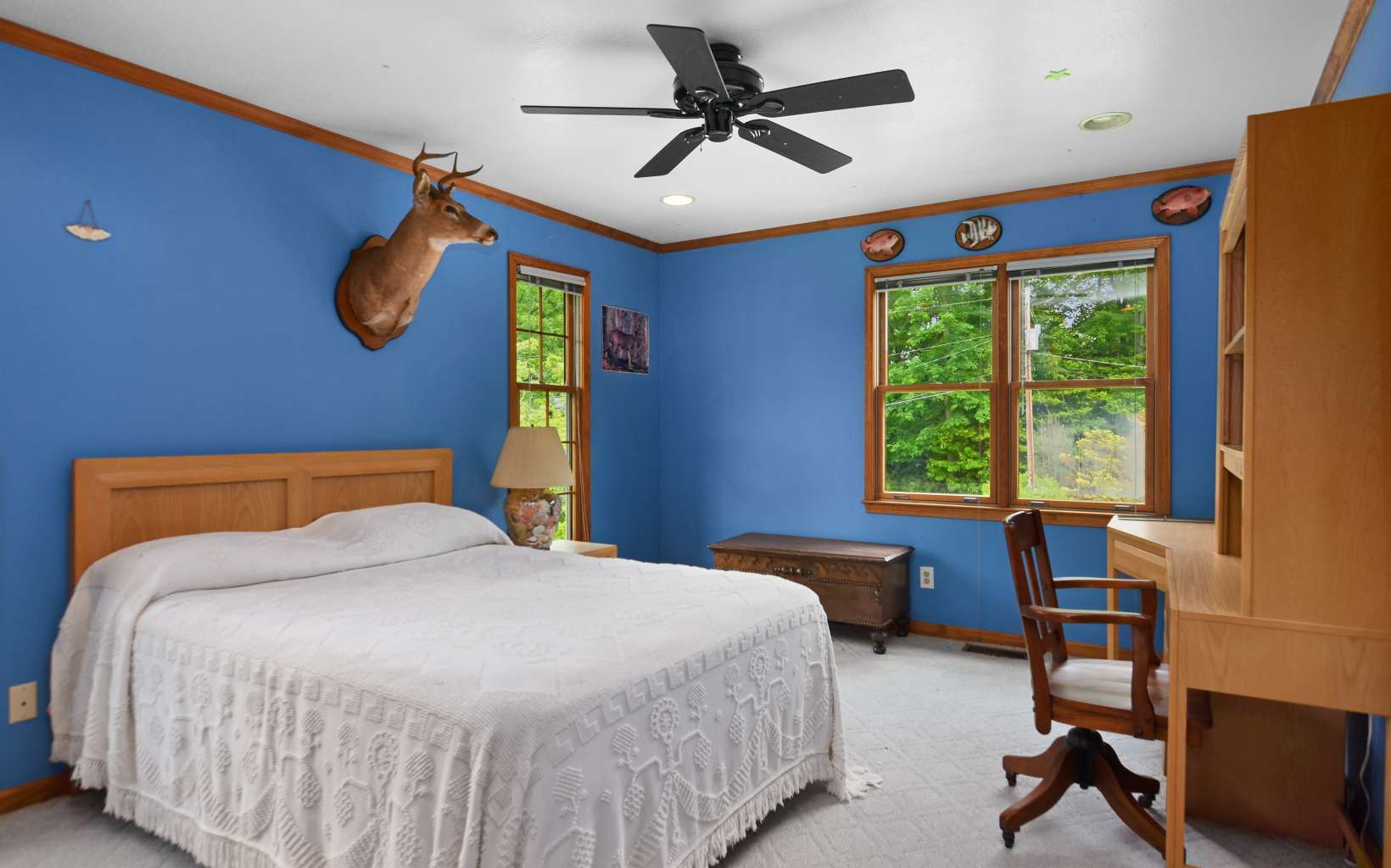 2850 Appalachian Highway Blue Ridge, GA 30513 - Photo 23 of 30 a bedroom with a bed and a chandelier