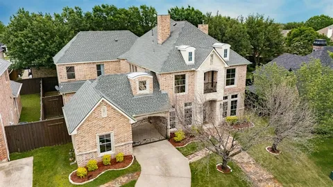 an aerial view of a house with yard