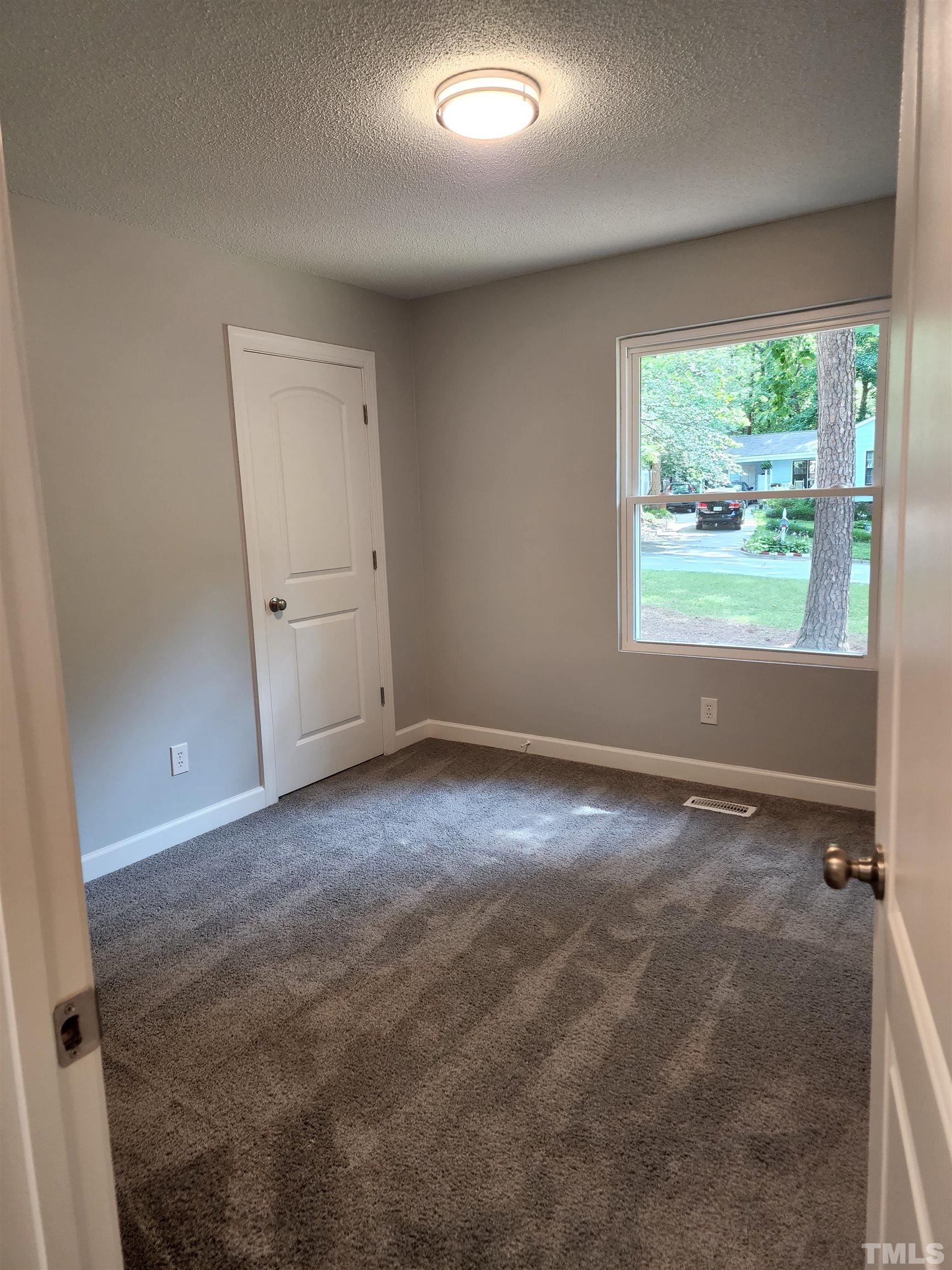 104 Trappers Run Drive Cary, NC 27513 - Photo 7 of 13 an empty room with a empty space and windows