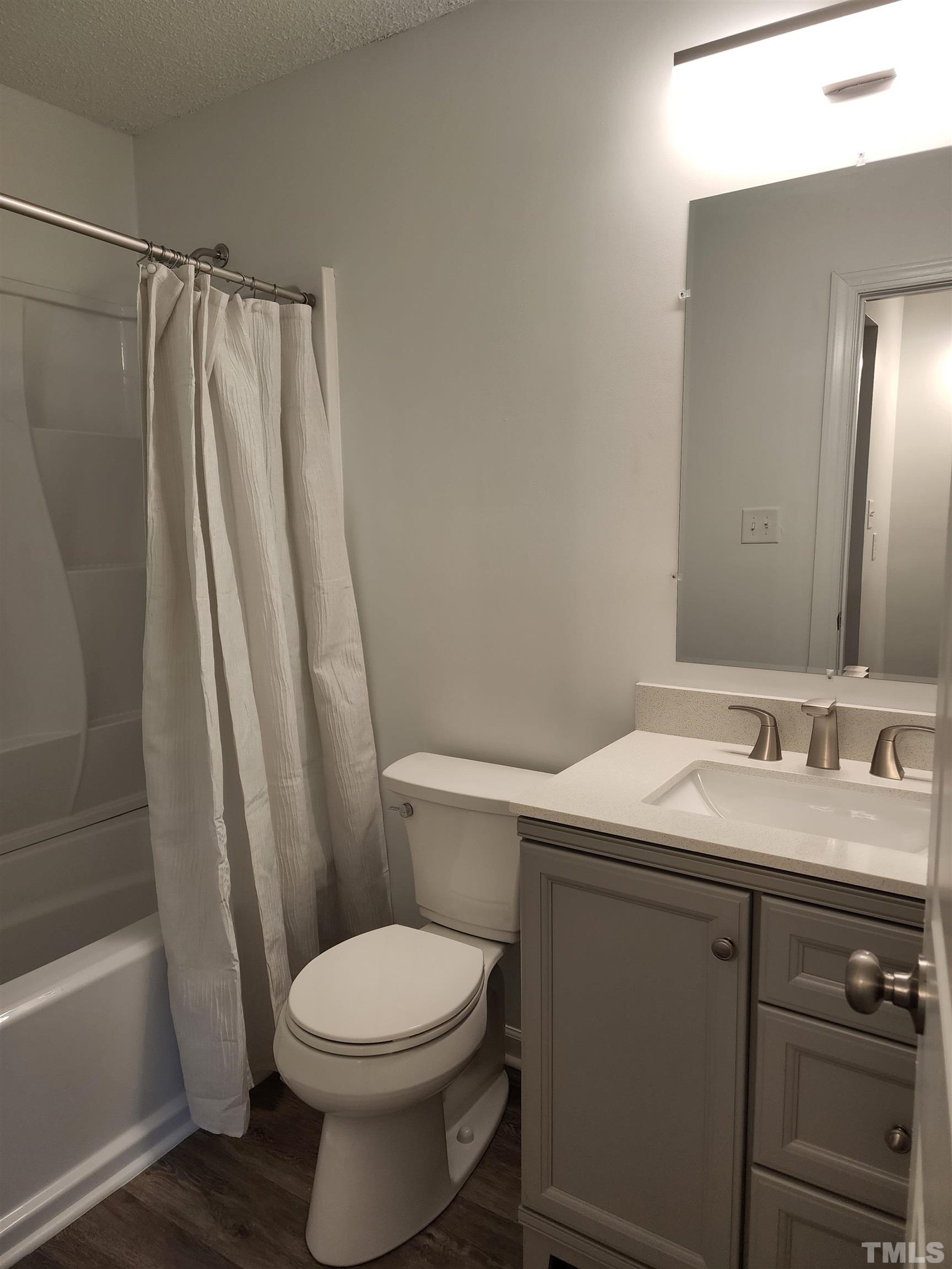 104 Trappers Run Drive Cary, NC 27513 - Photo 9 of 13 a bathroom with a sink a toilet and shower
