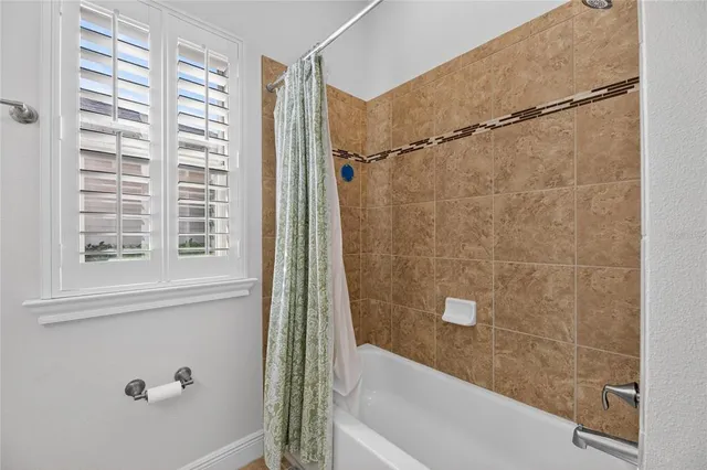 a white bath tub sitting next to a bathroom sink