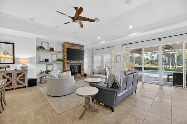 a living room with furniture a flat screen tv and a table