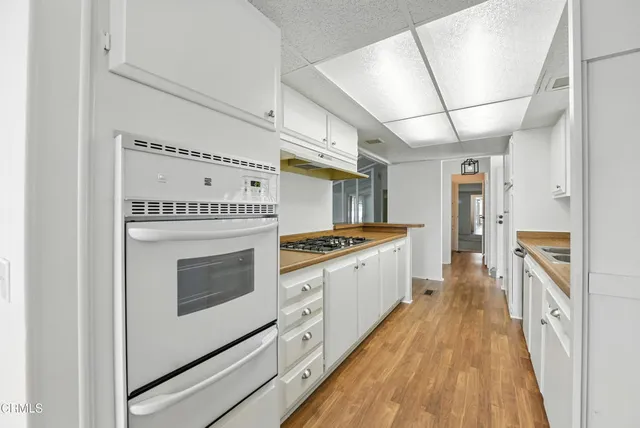 a kitchen with stainless steel appliances granite countertop a stove and a refrigerator