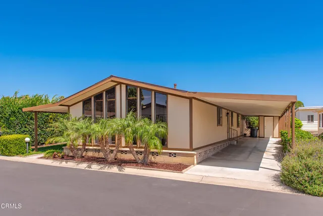 a front view of a house with yard and seating area