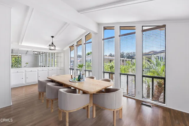a dining room with furniture window wooden floor