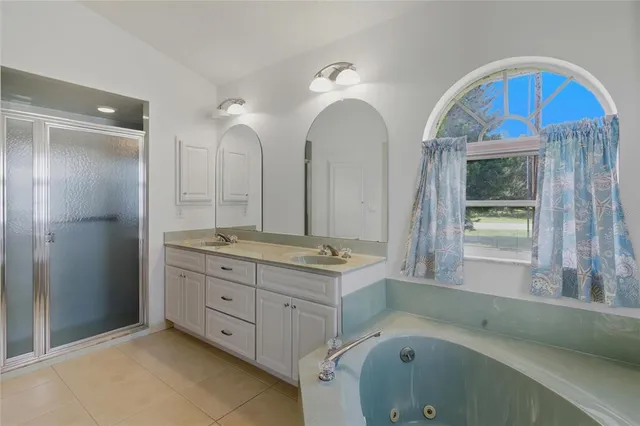 a bathroom with a tub sink and mirror