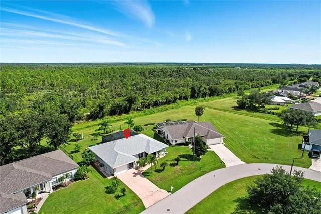 an aerial view of a house with yard