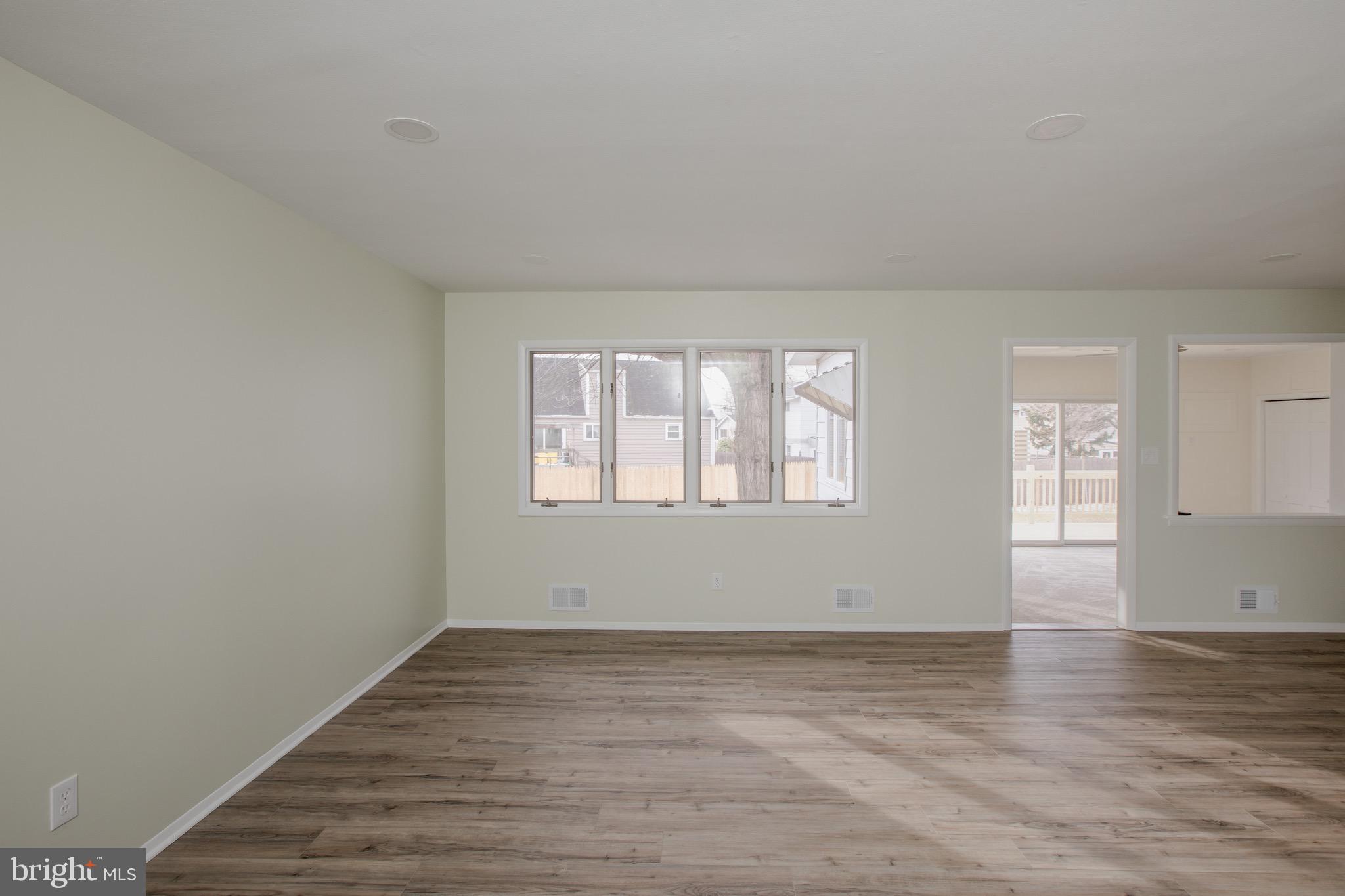 21 Rolling Lane Hamilton, NJ 08690 - Photo 11 of 40 wooden floor in an empty room with a window