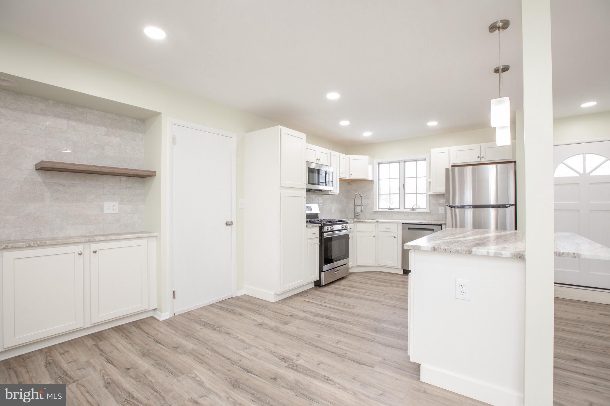 21 Rolling Lane Hamilton, NJ 08690 - Photo 12 of 40 a kitchen with a refrigerator and a stove top oven
