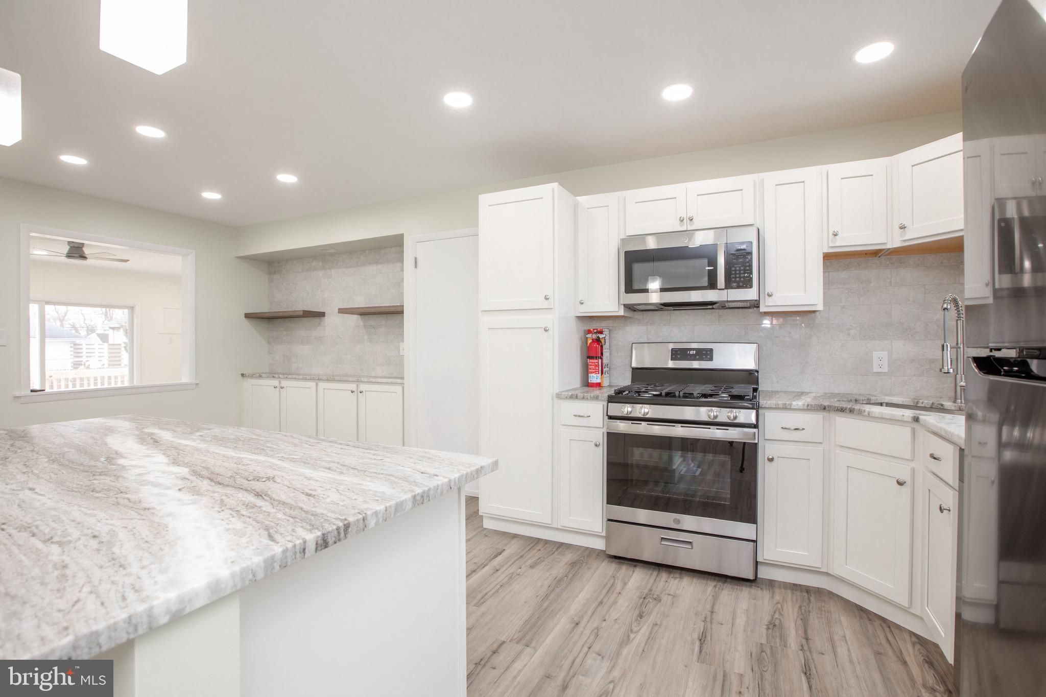 21 Rolling Lane Hamilton, NJ 08690 - Photo 13 of 40 a kitchen with granite countertop a stove and a sink
