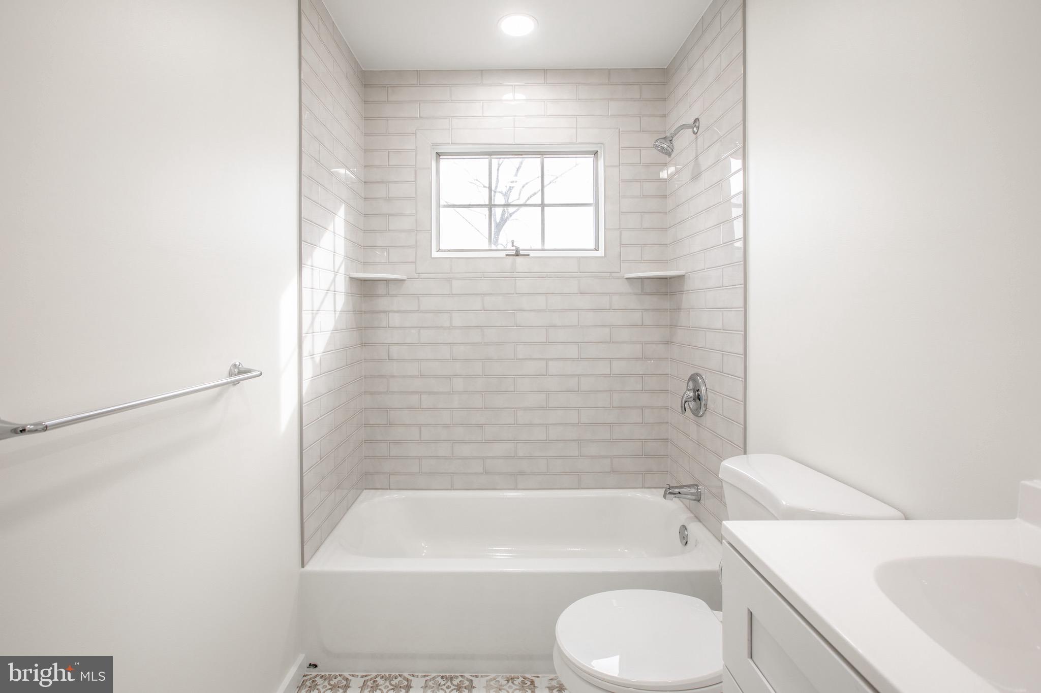 21 Rolling Lane Hamilton, NJ 08690 - Photo 29 of 40 a bathroom with a toilet a sink and bathtub