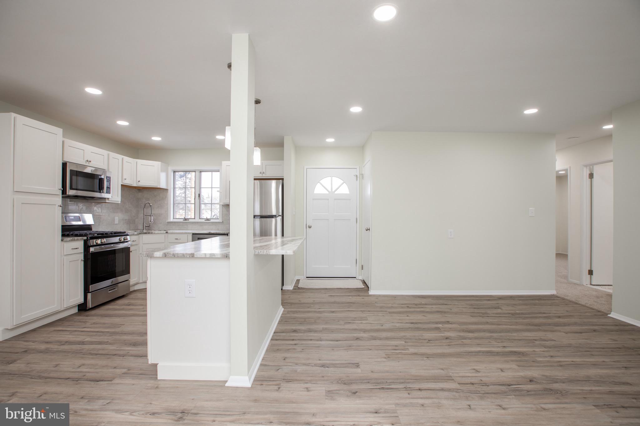 21 Rolling Lane Hamilton, NJ 08690 - Photo 10 of 40 a view of kitchen view wooden floor stainless steel appliances and cabinets