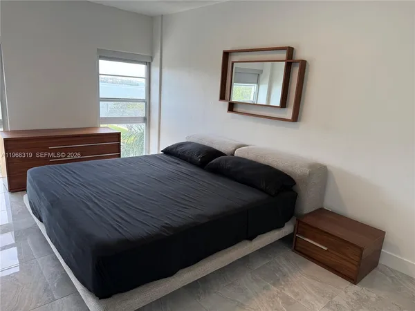 a view of a livingroom with furniture and an empty room