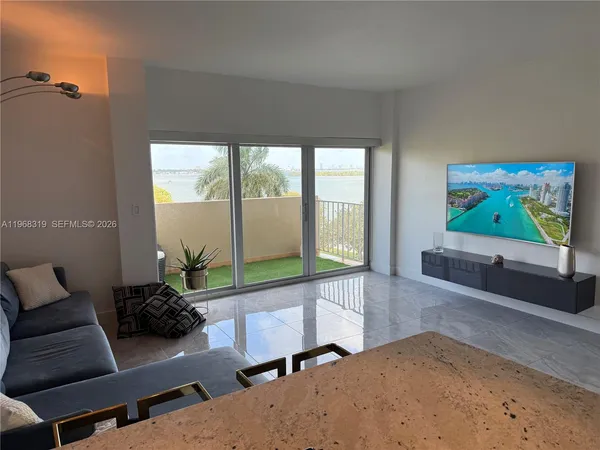 a living room with furniture and a large window
