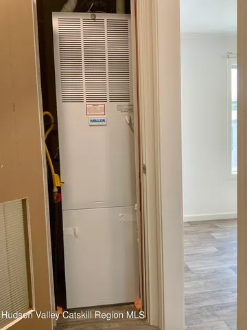 an empty room with a mirror and a sink