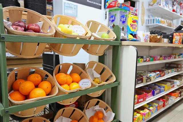 a store room filled with lots of fruit and a table