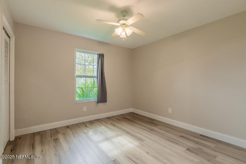 2168 Minorcan Street Middleburg, FL 32068 - Photo 12 of 24 an empty room with a window and a ceiling fan