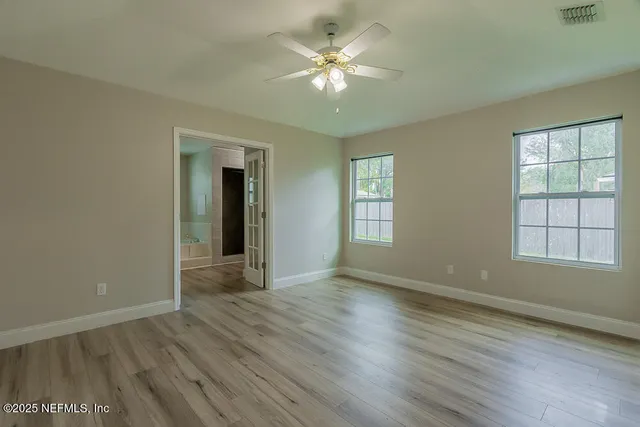 wooden floor in an empty room with a window