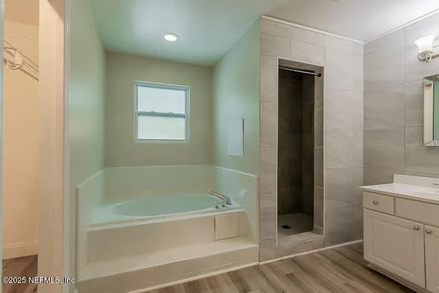 a bathroom with a bathtub and shower