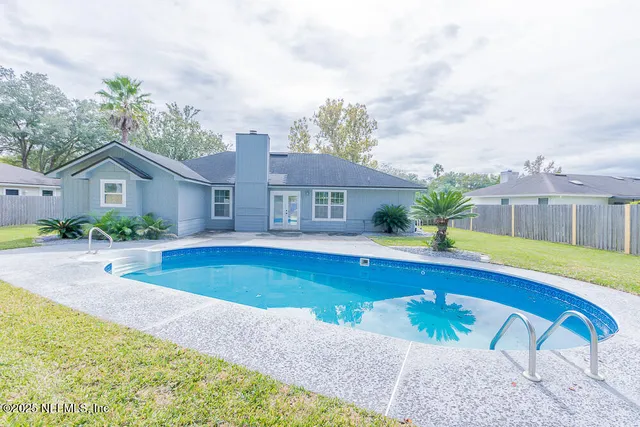 a view of a house with swimming pool and a porch