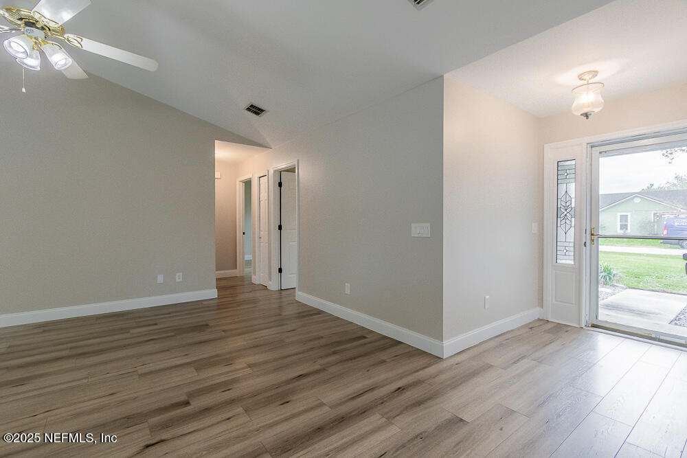 2168 Minorcan Street Middleburg, FL 32068 - Photo 3 of 24 a view of an empty room with window and wooden floor