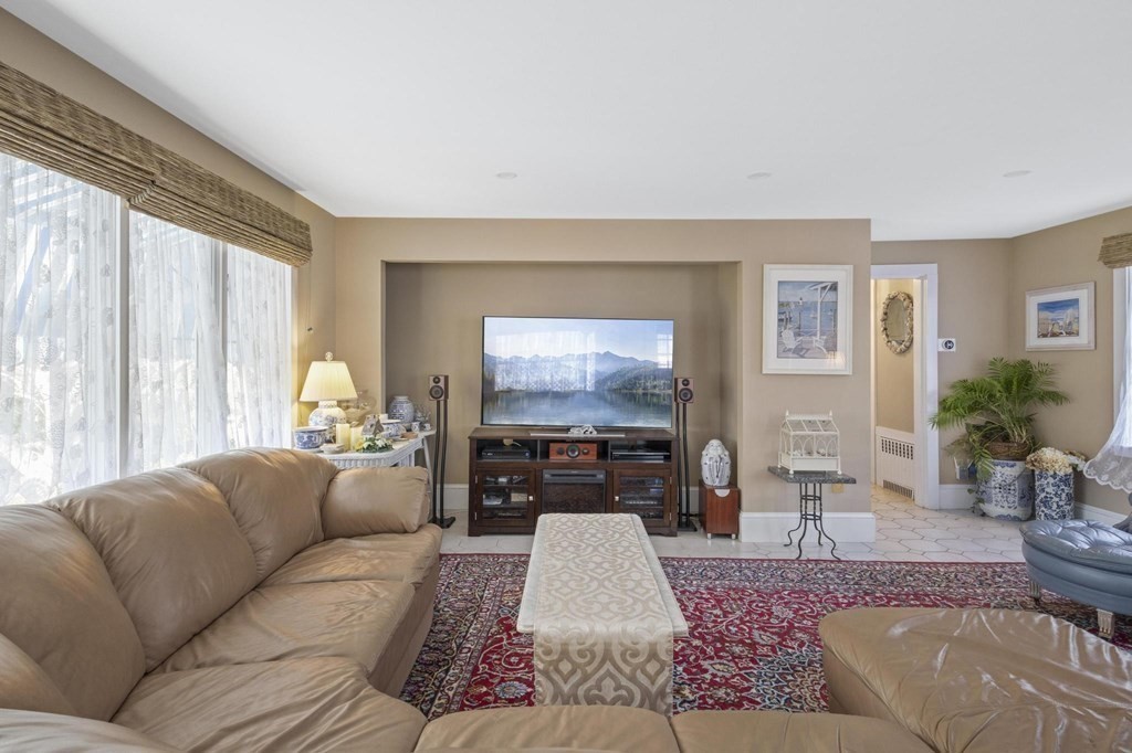 928 Shore Road Bourne, MA 02559 - Photo 12 of 32 a living room with furniture and a flat screen tv